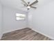 This bedroom features wood-look flooring, a modern ceiling fan, and a window with natural light at 4505 18Th W Ave, Bradenton, FL 34209