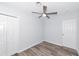 A bright bedroom with wood-look floors, a ceiling fan, closet, and a white interior door at 4505 18Th W Ave, Bradenton, FL 34209