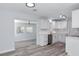Open-concept kitchen features white cabinets, stainless steel appliances, and a view to a living area at 4505 18Th W Ave, Bradenton, FL 34209