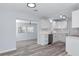 Open-concept kitchen features white cabinets, stainless steel appliances, and a view to a living area at 4505 18Th W Ave, Bradenton, FL 34209