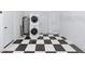 Laundry area with stacked washer/dryer hookups and black and white tile floors at 4505 18Th W Ave, Bradenton, FL 34209