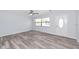Living room with wood-look floors, white trim, and a front door at 4505 18Th W Ave, Bradenton, FL 34209