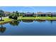 A beautiful backyard with a lush green lawn and a tranquil lake view in a well-maintained community at 4704 Sarca Ct, Lakewood Ranch, FL 34211
