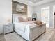 This primary bedroom boasts a tray ceiling, wood accent wall, and luxurious rug for a relaxing, bright space at 4704 Sarca Ct, Lakewood Ranch, FL 34211