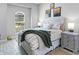 Bright bedroom featuring a large window, wood-look flooring, and neutral-toned bedding at 4704 Sarca Ct, Lakewood Ranch, FL 34211