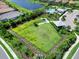 Aerial view of community dog park, a secure and spacious area for pets to play and socialize at 4704 Sarca Ct, Lakewood Ranch, FL 34211