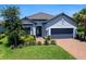 Charming single-Gathering home with a well-manicured lawn, beautiful landscaping, and a welcoming entrance at 4704 Sarca Ct, Lakewood Ranch, FL 34211