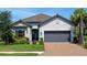 Charming single-story home featuring a neutral color palette, a two-car garage, and well-manicured landscaping at 4704 Sarca Ct, Lakewood Ranch, FL 34211