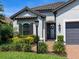 Home features a leaded glass front door, an arched window and lush landscaping at 4704 Sarca Ct, Lakewood Ranch, FL 34211