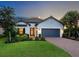 Charming one-story home featuring a 2-car garage, landscaped yard, and welcoming entrance, perfect for comfortable living at 4704 Sarca Ct, Lakewood Ranch, FL 34211