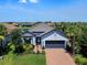 Attractive home with a 2-car garage, lush landscaping, and a well-maintained lawn in a desirable neighborhood setting at 4704 Sarca Ct, Lakewood Ranch, FL 34211