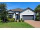 Charming home featuring a tile roof, neutral stucco, brick driveway and attractive landscaping at 4704 Sarca Ct, Lakewood Ranch, FL 34211