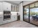 Modern kitchen includes stainless steel appliances, wine cooler, and offers access to the outdoor cooking area at 4704 Sarca Ct, Lakewood Ranch, FL 34211