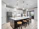Spacious kitchen with large island, stainless steel appliances, designer pendant lighting and wood-look tile floors at 4704 Sarca Ct, Lakewood Ranch, FL 34211
