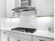 Elegant kitchen features white cabinets, tile backsplash, stainless hood and appliances, with great lighting at 4704 Sarca Ct, Lakewood Ranch, FL 34211