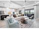 Bright living room features tray ceiling, fan, plush furniture, tile floors and access to the outdoor patio at 4704 Sarca Ct, Lakewood Ranch, FL 34211