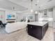 Open living area with modern kitchen island, bright lighting, and plush furniture for relaxing at 4704 Sarca Ct, Lakewood Ranch, FL 34211