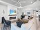 Bright living room with fireplace, light colored walls, and seamless access to the dining room at 4704 Sarca Ct, Lakewood Ranch, FL 34211
