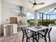 Outdoor kitchen with grill, stainless steel appliances, and a view of the lake at 4704 Sarca Ct, Lakewood Ranch, FL 34211