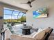 Inviting outdoor living space with comfortable seating, a stylish fire pit table, and a view of the pool and lake at 4704 Sarca Ct, Lakewood Ranch, FL 34211