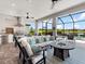 Outdoor seating area with fire pit, overlooking pool, lake and outdoor kitchen at 4704 Sarca Ct, Lakewood Ranch, FL 34211