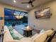 Cozy outdoor space featuring a fire pit, comfortable seating, and a large TV, ideal for relaxing evenings at 4704 Sarca Ct, Lakewood Ranch, FL 34211