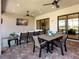 Covered outdoor patio with multiple seating areas, dining, and a view of the water at 4704 Sarca Ct, Lakewood Ranch, FL 34211
