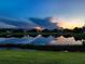 Beautiful pond view reflecting the sunset and nearby homes, creating a serene and picturesque landscape at 4704 Sarca Ct, Lakewood Ranch, FL 34211