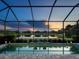 Relaxing screened-in pool offering serene views of the lake and neighborhood homes, perfect for tranquil evenings at 4704 Sarca Ct, Lakewood Ranch, FL 34211