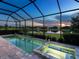 Inviting screened-in pool and spa with tranquil lake views, perfect for relaxation and entertainment at 4704 Sarca Ct, Lakewood Ranch, FL 34211