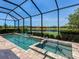 Screened-in pool and hot tub overlooking a lake at 4704 Sarca Ct, Lakewood Ranch, FL 34211
