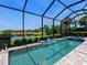 Inviting screened-in pool and spa area for outdoor relaxation, providing a private oasis with scenic water views at 4704 Sarca Ct, Lakewood Ranch, FL 34211