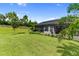 Spacious backyard features lush greenery, tropical plants, and a serene, landscaped setting at 4735 Cassio Ct, Bradenton, FL 34211
