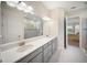 Bright bathroom with double vanity, stylish mirrors, and a glass-enclosed shower at 4735 Cassio Ct, Bradenton, FL 34211