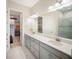 Bright bathroom with double vanity, quartz counters, and walk-in closet at 4735 Cassio Ct, Bradenton, FL 34211