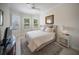 Bright bedroom with shuttered windows, TV, and stylish decor at 4735 Cassio Ct, Bradenton, FL 34211
