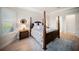 Bright bedroom features hardwood floors, four poster bed, and ensuite bathroom at 4735 Cassio Ct, Bradenton, FL 34211