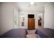 Neutral bedroom features TV, walk-in closet, and ensuite bath at 4735 Cassio Ct, Bradenton, FL 34211