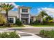 A welcoming clubhouse boasts modern architectural design and lush tropical landscaping at 4735 Cassio Ct, Bradenton, FL 34211