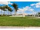 Grand community entrance with lush landscaping and prominent signage under a beautiful sky at 4735 Cassio Ct, Bradenton, FL 34211