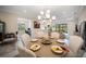 Cozy dining area featuring a round wooden table, cushioned chairs, and decorative table settings at 4735 Cassio Ct, Bradenton, FL 34211