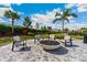 A cozy fire pit provides a social gathering spot amidst manicured landscaping at 4735 Cassio Ct, Bradenton, FL 34211