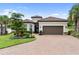 Charming single-story home with a paver driveway, manicured lawn, and a well-maintained landscape at 4735 Cassio Ct, Bradenton, FL 34211