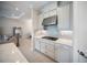 Modern kitchen features sleek cabinetry, stainless steel range hood and cooktop at 4735 Cassio Ct, Bradenton, FL 34211