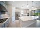 This spacious kitchen features a large island, modern appliances and a view to the pool at 4735 Cassio Ct, Bradenton, FL 34211