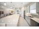 Well-lit kitchen with stainless steel appliances and a large island, flowing into the dining and living areas at 4735 Cassio Ct, Bradenton, FL 34211