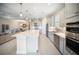 Modern kitchen featuring stainless steel appliances and a center island open to the living space at 4735 Cassio Ct, Bradenton, FL 34211
