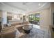 Inviting living room with sliding glass doors to the backyard, an open view of the modern kitchen at 4735 Cassio Ct, Bradenton, FL 34211