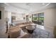 Open-concept living room with view to the lanai and pool offers a luxurious living space at 4735 Cassio Ct, Bradenton, FL 34211