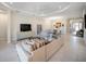 Spacious living room with neutral tones, dining area, and access to other rooms in an open layout at 4735 Cassio Ct, Bradenton, FL 34211